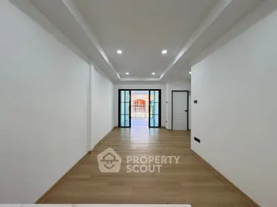 Spacious modern living room with wooden flooring and large windows