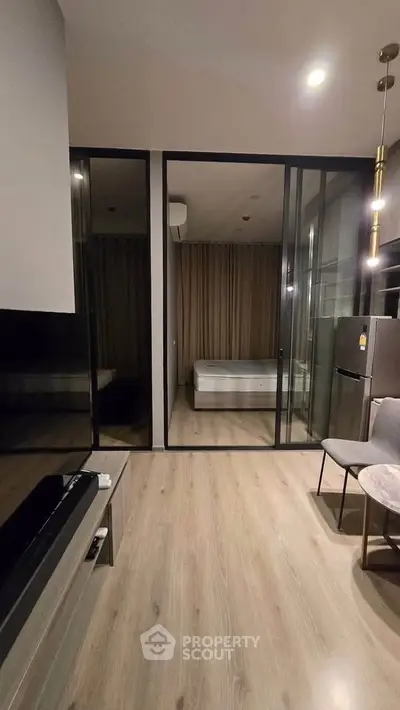 Modern studio apartment with glass partition and sleek furnishings