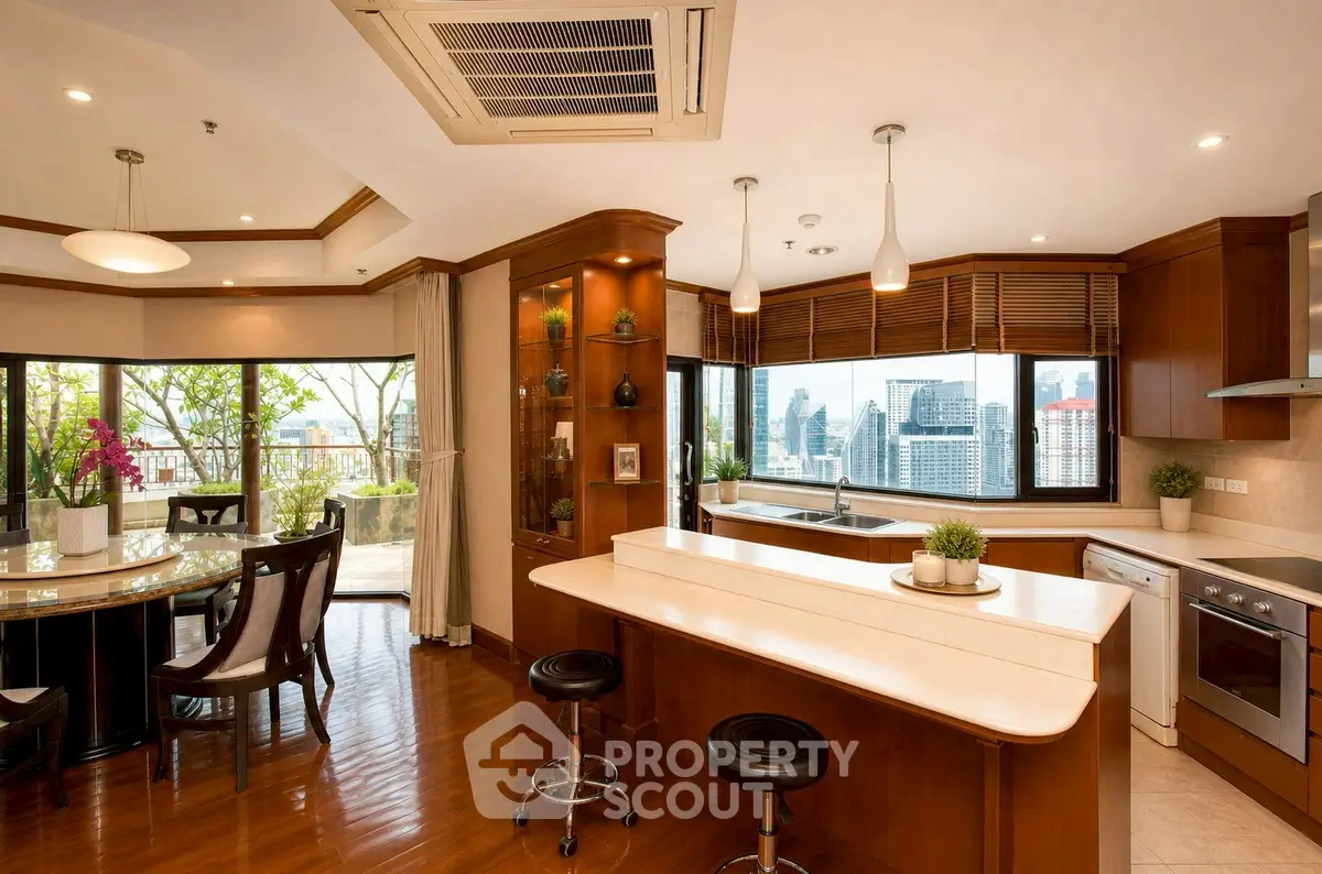 Luxurious open-plan kitchen and dining area with city view and balcony access.