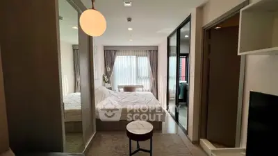 Modern bedroom with large window and stylish decor in a contemporary apartment.