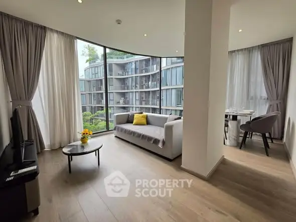 Modern living room with large windows and stylish furniture in a contemporary apartment.