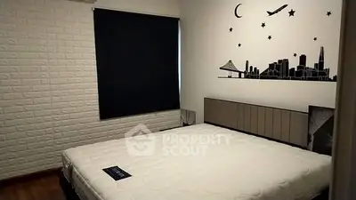 Modern bedroom with stylish wall art and cozy ambiance.