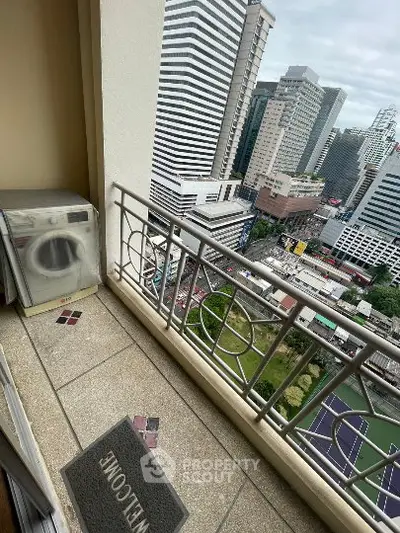 High-rise balcony with cityscape view and washing machine, perfect urban living.