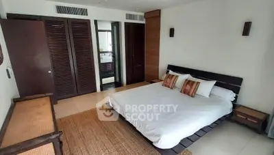 Spacious modern bedroom with wooden accents and cozy decor