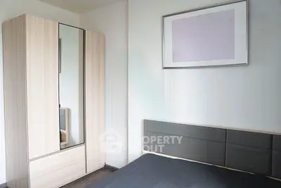 Modern bedroom with sleek wardrobe and stylish bed in minimalist design.