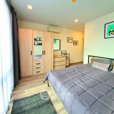 Spacious modern bedroom with stylish decor and ample natural light