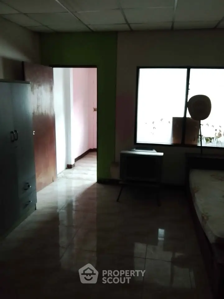 Cozy bedroom with natural light and simple furnishings, ideal for minimalist living.