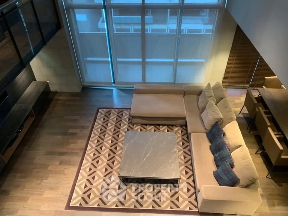 Spacious modern living room with large windows and stylish furniture