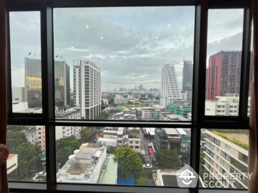 Stunning cityscape view from high-rise apartment window in urban setting