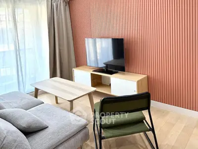 Modern living room with stylish TV setup and cozy seating area