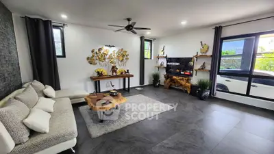 Spacious modern living room with stylish decor and large windows