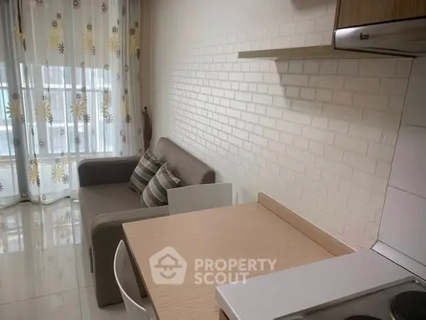 Modern compact living room with cozy sofa and stylish kitchen area