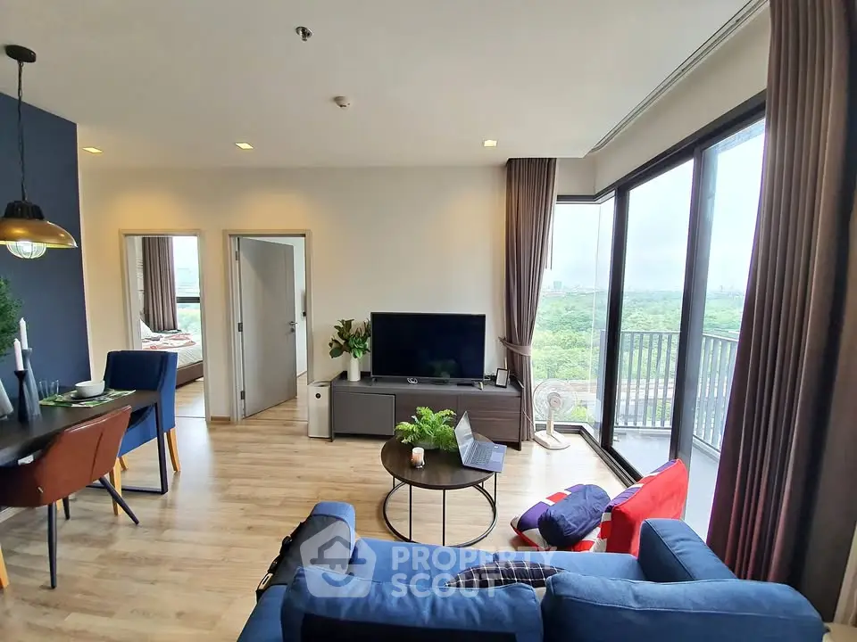 Spacious modern living room with large windows and balcony offering stunning views.