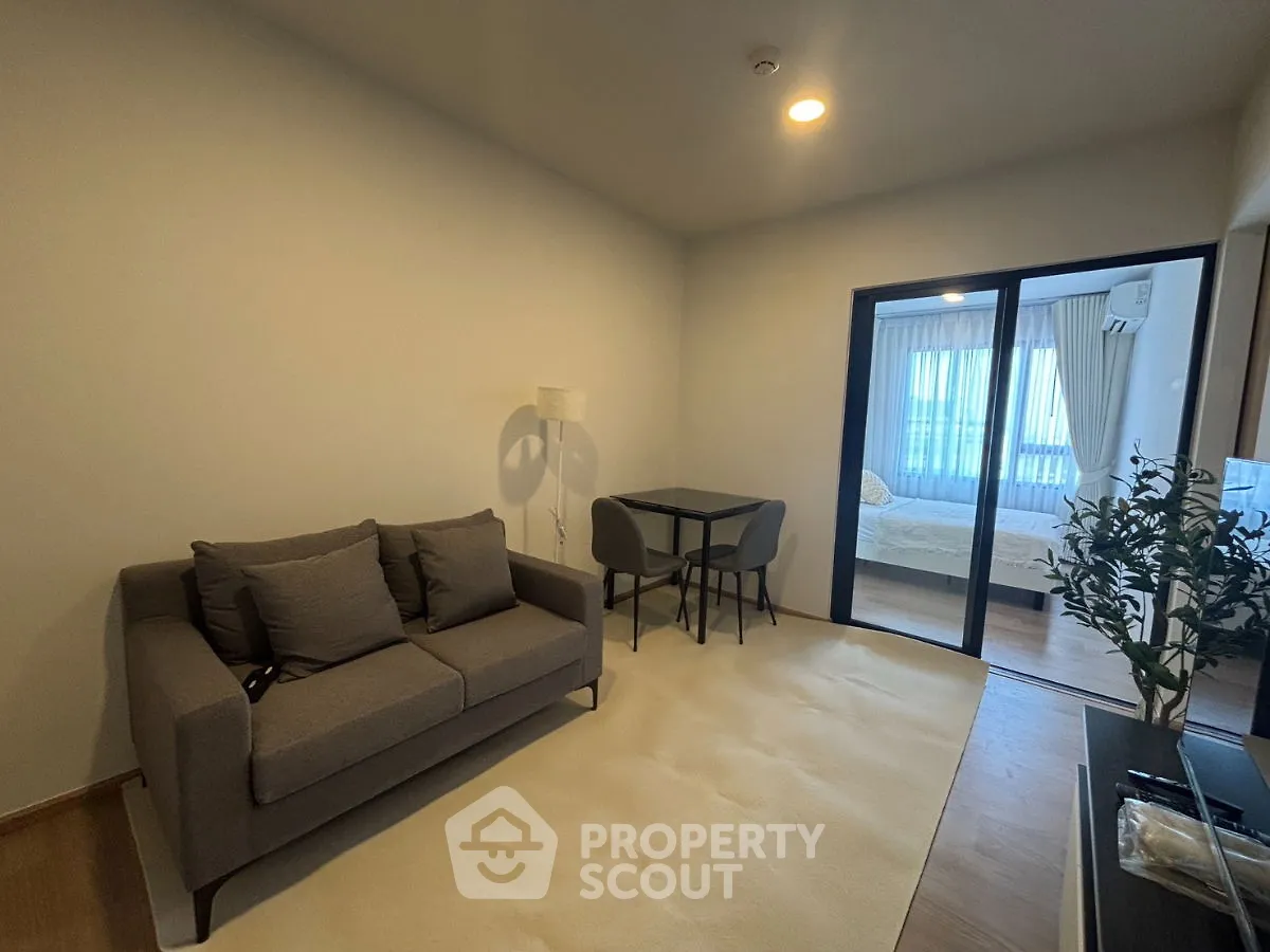 Modern living room with cozy sofa and dining area in stylish apartment