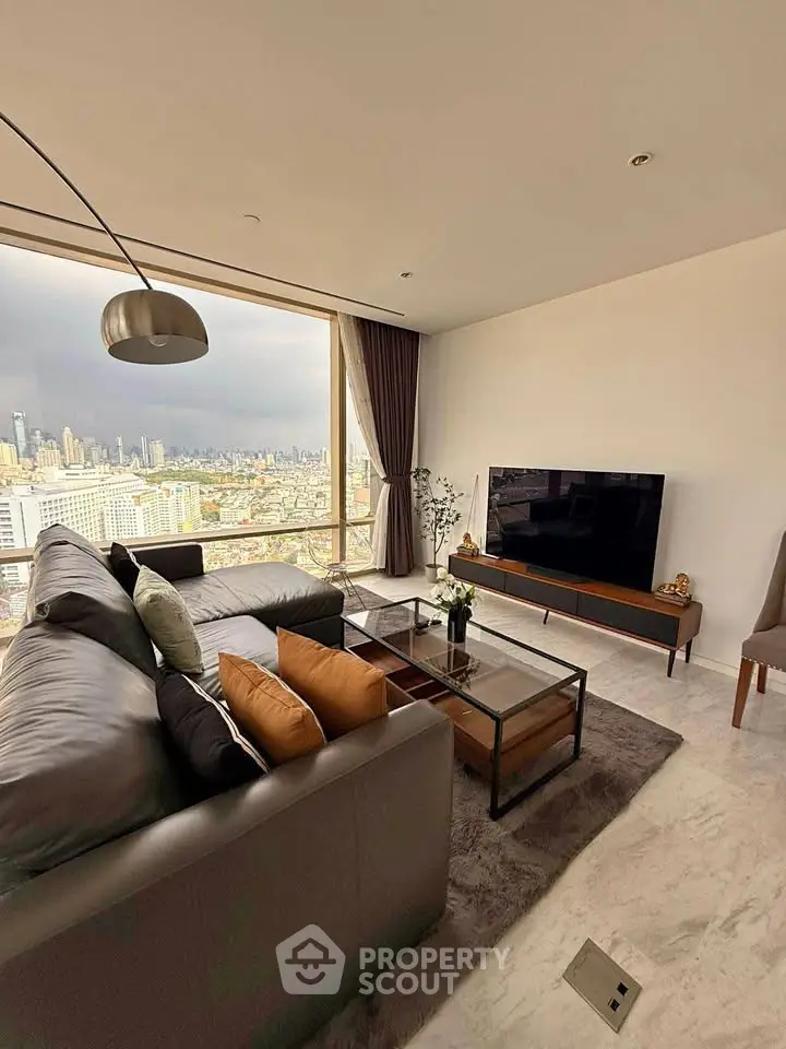 Luxurious living room with stunning city view, modern furniture, and elegant decor in high-rise apartment.