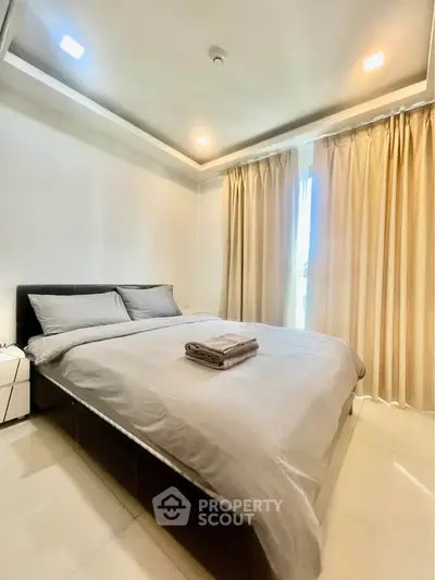 Spacious bedroom with modern decor and natural light in a luxury apartment.