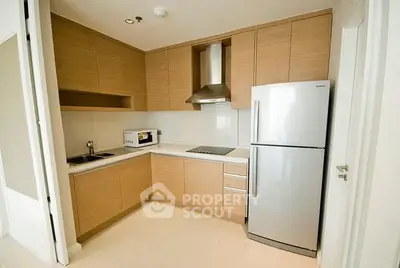 Modern kitchen with sleek wooden cabinets and stainless steel appliances