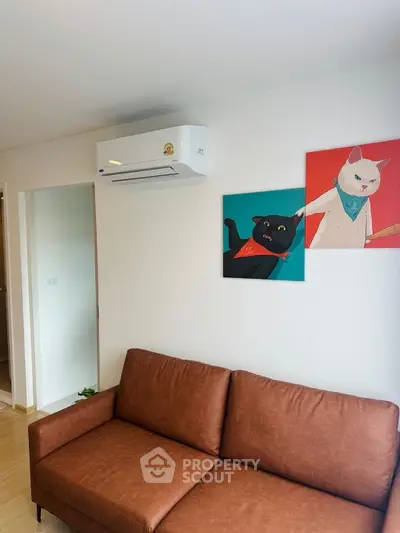 Cozy living room with brown leather sofa and modern wall art