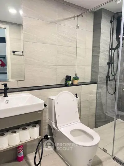 Modern bathroom with sleek fixtures and glass shower enclosure
