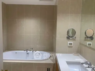 Luxurious bathroom with elegant bathtub and modern fixtures in a stylish real estate property.