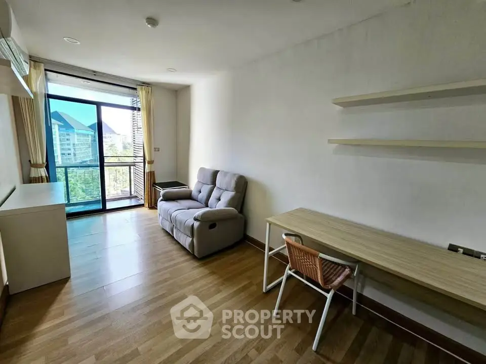 Modern living room with cozy sofa and scenic view from large window, perfect for relaxation.