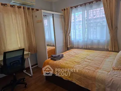 Cozy bedroom with large windows, mirrored wardrobe, and a study desk, perfect for comfort and productivity.