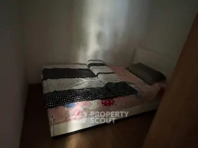 Cozy small bedroom with single bed and soft lighting, perfect for minimalist living.