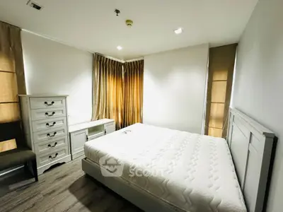 Spacious bedroom with modern furniture and natural light