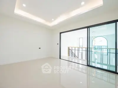 Spacious modern living room with glossy floors and large sliding glass doors leading to a bright balcony.