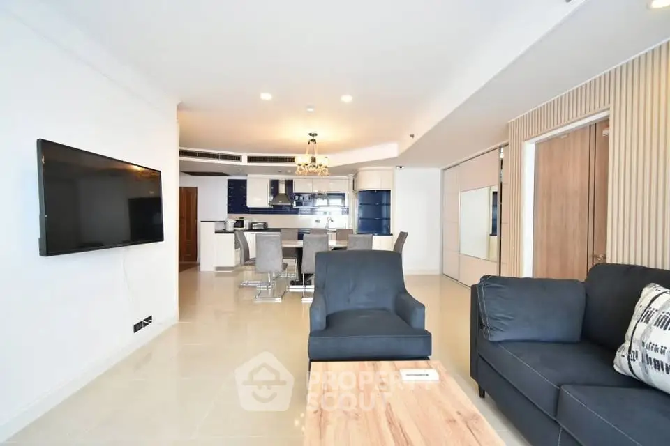 Spacious modern living room with open kitchen and elegant furnishings