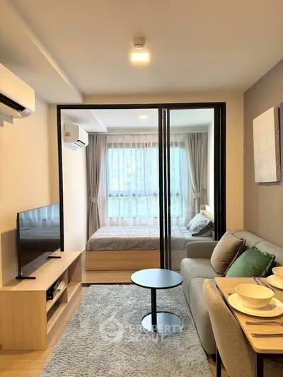 Modern studio apartment with cozy living area and stylish bedroom