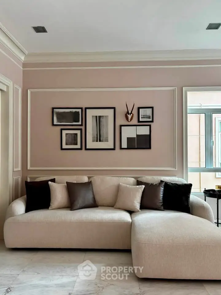 Elegant living room with modern beige sofa and stylish wall art, perfect for contemporary home decor.
