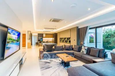 Luxurious modern living room with spacious seating and open kitchen layout, perfect for entertaining.
