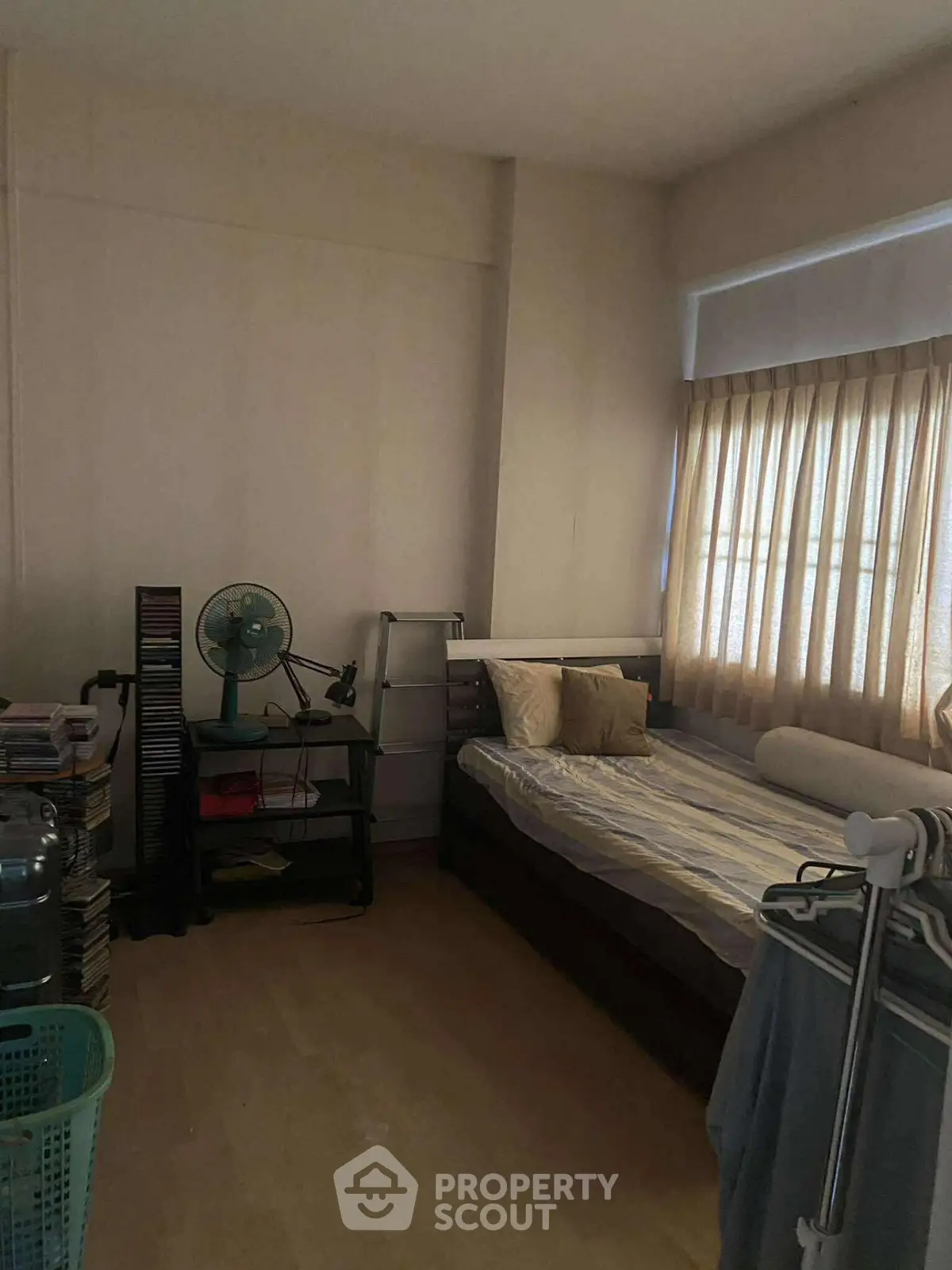 Cozy bedroom with natural light and minimalist decor, perfect for relaxation and comfort.