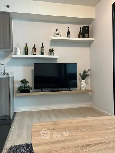 Modern living room with sleek TV setup and stylish shelving decor