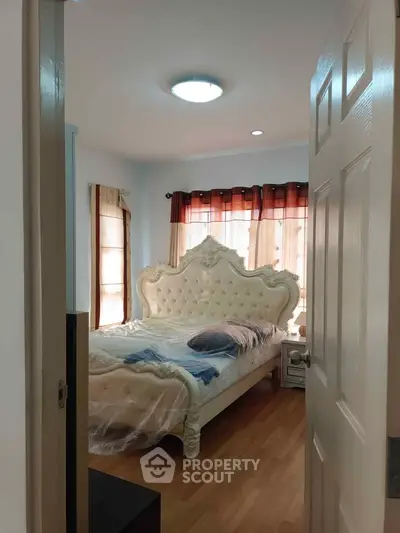 Elegant bedroom with luxurious bed and natural light, perfect for relaxation and comfort.