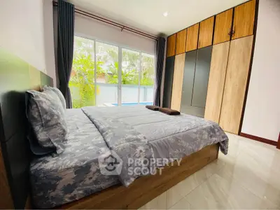 Spacious bedroom with large window and built-in wardrobe