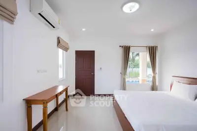 Bright and airy bedroom with modern furnishings and large windows offering serene views.