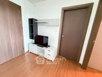 Modern living room corner with TV and wooden flooring