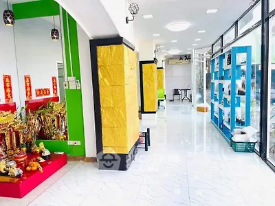 Bright commercial space with colorful decor and large windows, ideal for retail or office use.