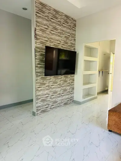 Modern living room with stylish TV wall and sleek tile flooring