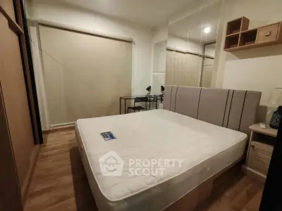 Cozy bedroom with modern furnishings and ample natural light, perfect for relaxation and comfort.