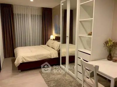 Cozy bedroom with modern decor and study area, featuring a comfortable bed and ample storage.