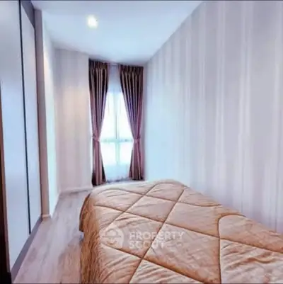 Cozy bedroom with elegant curtains and soft lighting, perfect for relaxation.