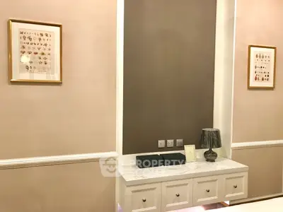 Elegant interior with framed art and stylish console table in modern living room.