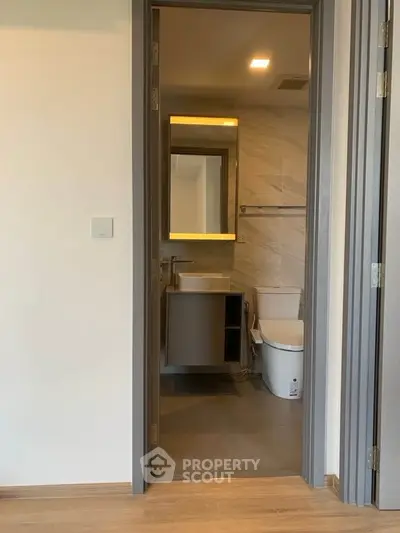 Modern bathroom with sleek fixtures and elegant design in a contemporary apartment.