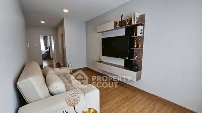 Modern living room with sleek TV unit and cozy sofa, perfect for relaxation.