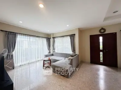 Spacious living room with natural light and modern furniture
