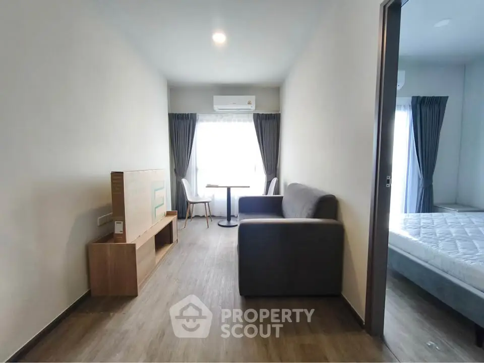 Modern apartment interior with cozy living room and bedroom, featuring stylish furniture and natural light.