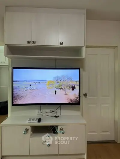 Modern living room with wall-mounted TV and stylish cabinetry